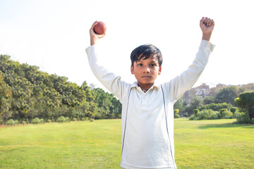 A boy celebration taking a catch During a Cricket Game