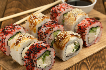 assorted rolls and sushi on the table. chopsticks and sauce	
