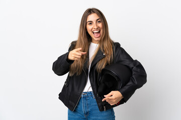 Young Woman holding a motorcycle helmet over isolated white background points finger at you