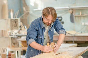 Carpenter planed wood in a workshop