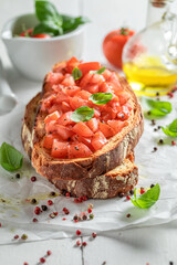 Crisp bruschetta with fresh tomato as starter. Italian cuisine.