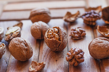 broken walnuts on a wooden background. split nuts near the nutcracker
