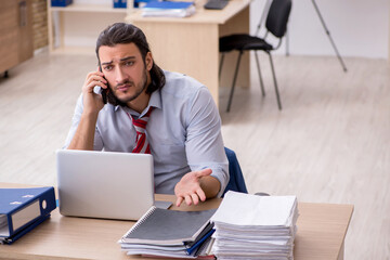 Young male employee unhappy with excessive work