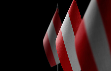 Small national flags of the Austria on a black background