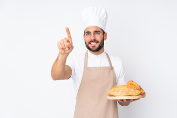 Male baker holding a table with several breads isolated on white background touching on transparent screen - Powered by Adobe