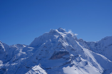 Fototapeta na wymiar Panorama of Bernese Alps with Mountain Peak Jungfrau (virgin), seen from Mürren, Switzerland.