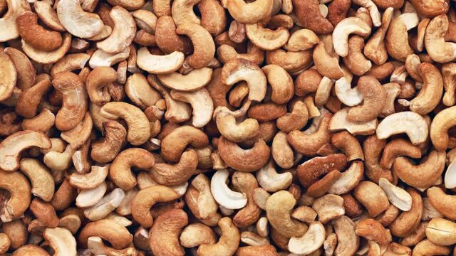 Moving cashew nuts peeled full. View from above.