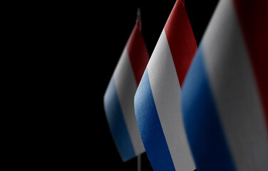 Small national flags of the Netherlands on a black background