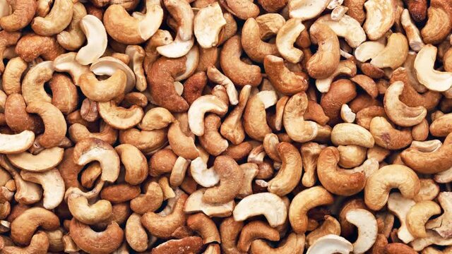 Moving cashew nuts peeled full. View from above.