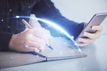 Double exposure of social network sketch hologram and woman holding and using a mobile device.