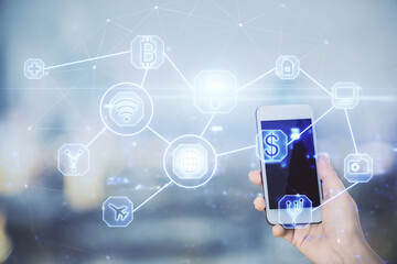 Double exposure of social network sketch hologram and woman holding and using a mobile device.