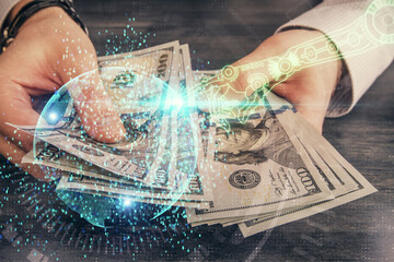 Multi exposure of technology drawing hologram and us dollars bills and man hands. Data concept