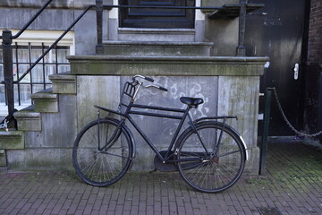 Fototapeta na wymiar Amsterdam Vintage Black Bicycle with Entrance Steps