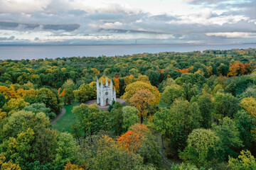 Obraz premium Panoramic aerial view of the Church in the medieval Gothic style in the park of St. Petersburg. Gothic chapel. Autumn.