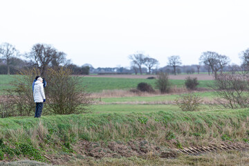 Fototapeta na wymiar A unknown couple taking a walk through the beautiful Suffolk countryside on a cold winters day