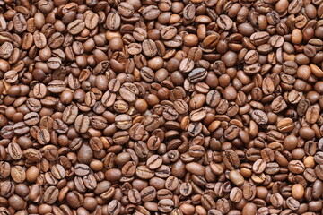 A lot of grains of aromatic divine coffee close-up.
