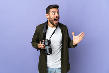 Photographer man over isolated purple background with surprise facial expression