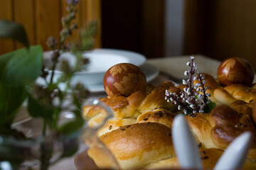 Easter decorated table with handmade braided bread and traditionally painted eggs