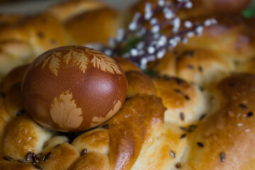 Close up of braided bread with Easter painted traditionally egg