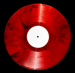 vinyl record of red color on a black background close-up