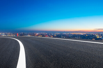 Fototapeta premium Empty asphalt road and Shanghai skyline with buildings at night.