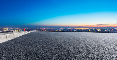 Empty asphalt road and Shanghai skyline with buildings at night.