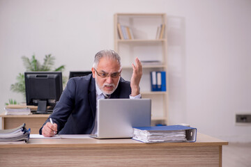Aged businessman employee sitting in the office