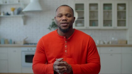 Lifestyle portrait of handsome african american male blogger in casual clothes live streaming vlog for followers, communicating and sharing experience with online audience while filming video for blog