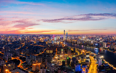 Aerial view of modern city skyline and buildings at night in Shanghai.