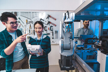 Meeting asian Engineers Maintenance Robot Arm at Lab. they are in a High Tech Research Laboratory with Modern Equipment. Professional Japanese Development Engineer .