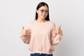 Young Chinese girl over isolated white background proud and self-satisfied