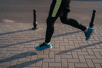 Man running legs in the city. Fitness, workout, sport, lifestyle concept.
