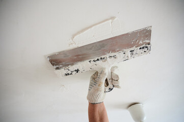 Mixer for building mixes in white liquid putty on the background of ready-made material for...