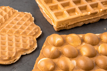 Three different waffles in square, heart and bubble shape.