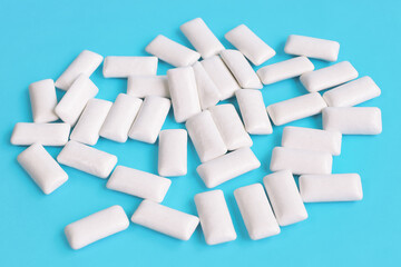 Mint chewing gum in the shape of a pillow on a blue background