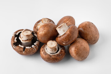Fresh mushrooms on a light background. Brown champignons. Bunch of mushrooms.