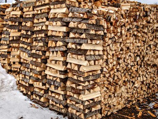 Firewood is split and stacked in even rows