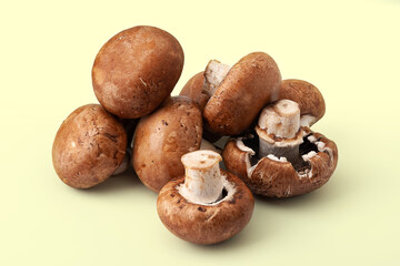 Fresh champignons on yellow background. Brown wet mushrooms. Bunch of raw mushrooms.