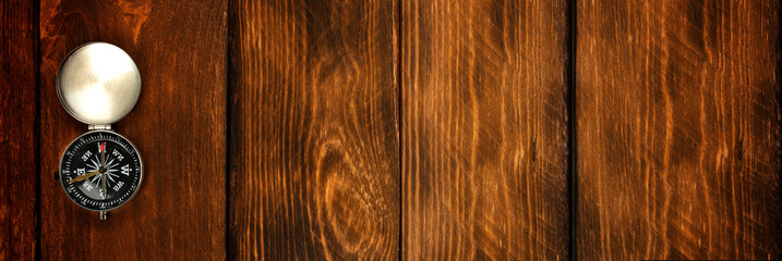 compass on the brown wooden table background