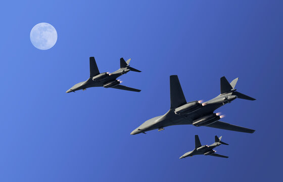 Three military fighter planes with exhaust flames during a surveillance flight in a blue clear night sky with moon and copy space