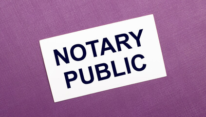 On a lilac background, a white card with the words NOTARY PUBLIC