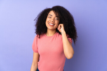 Young african american woman isolated on purple background laughing