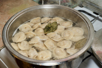 Casserole with boiling dumplings in boiling water