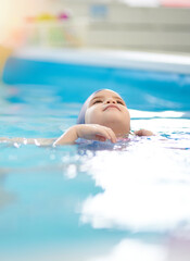 Portrait of child swimming on back