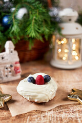 Cake decorated with blackberries and raspberries on the christmas table