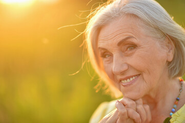 Happy senior woman  smiling in  park