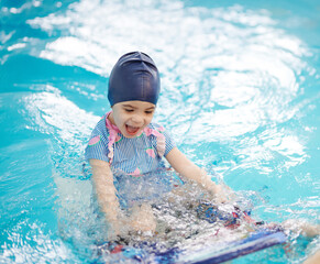 Happy girl on swimming lessons