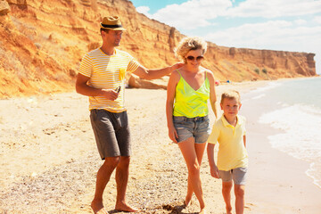 Active family, mother, father and son resting in the beach on vacation. people enjoy the sea, sand and healthy.