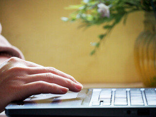 Woman working at home office hand on keyboard close up