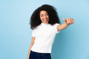 Young african american woman over isolated background giving a thumbs up gesture